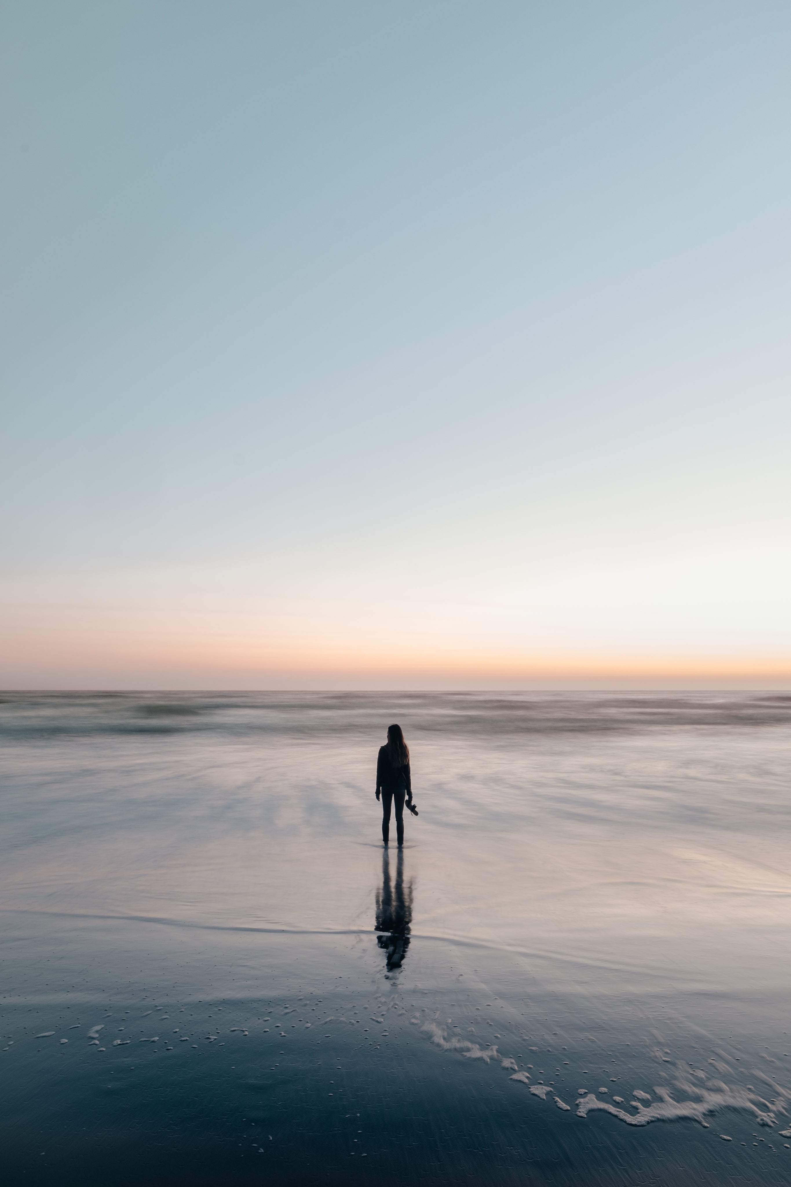 woman-wades-in-ocean-at-sunset.jpg